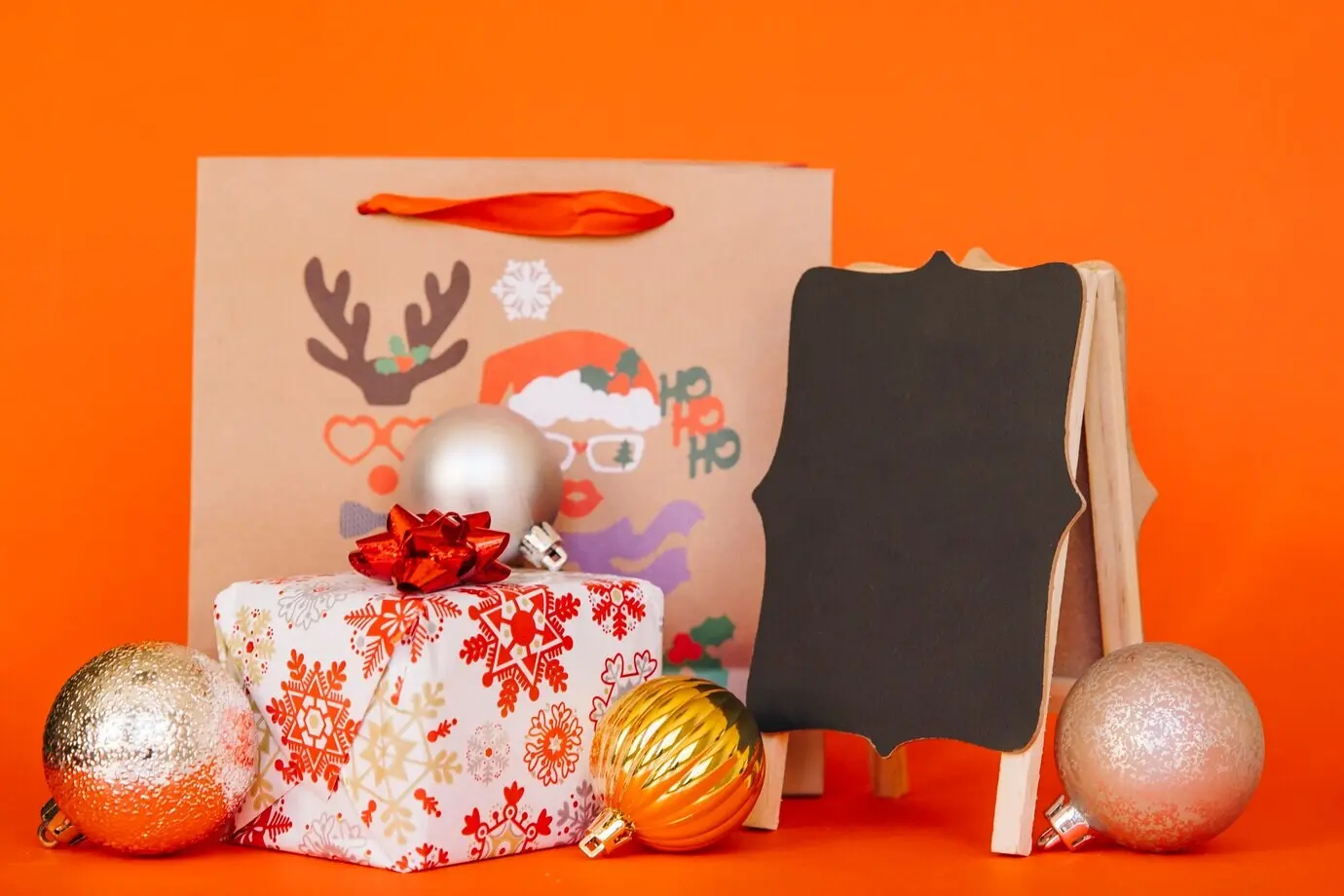 Christmas shopping arrangement with a board and a bag.